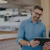 People smiling at a tablet